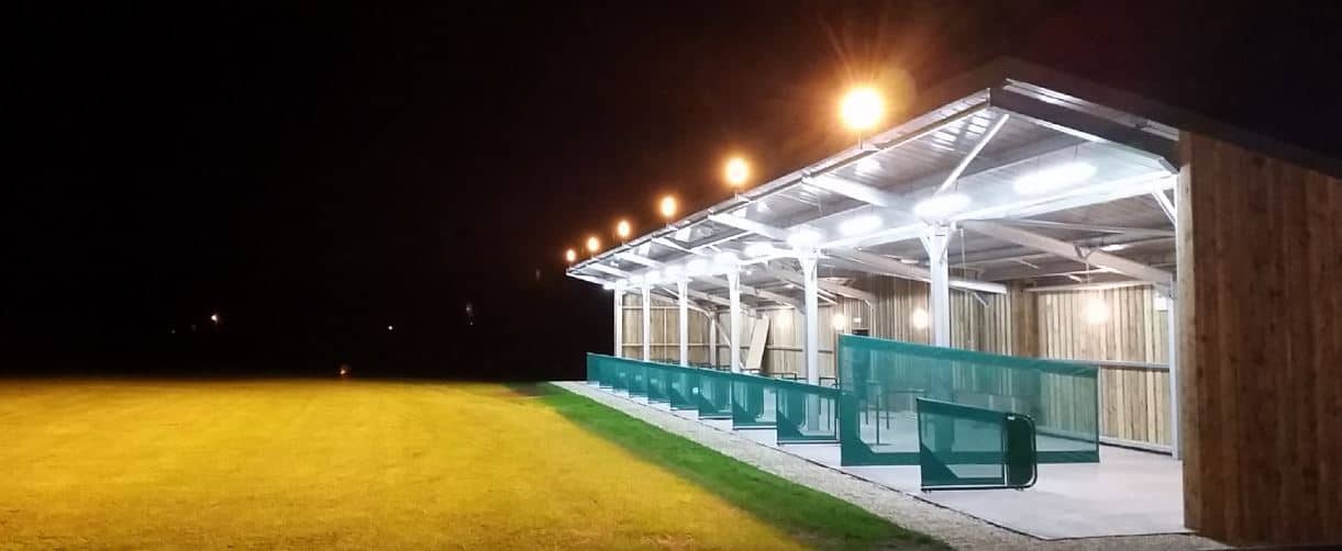 A picture of Sleight Valley Driving Range in the dark with floodlights lit up